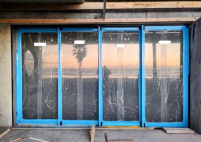 Aluminium sliding doors protected with Dewpoint Industries blue protective tape and glass film.