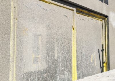 Aluminium window frames protected with yellow protective tape on a construction site in Cape Town.
