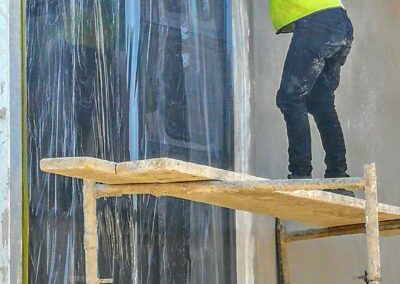 Aluminium window frames protected with yellow protective tape on a construction site in Cape Town.
